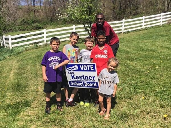 A family with a campaign sign.