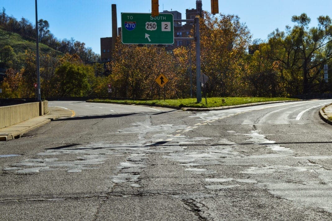 A pothole-filled area of roadway.