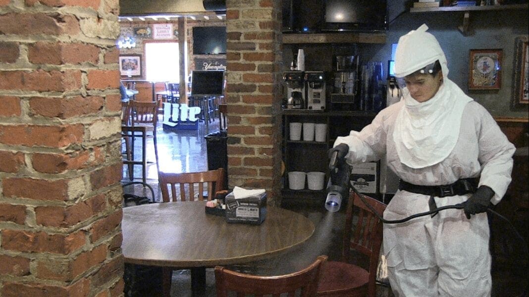 An employee wearing a hazmat suit.