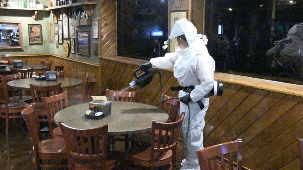 A crew member disinfecting a restaurant in Wheeling.