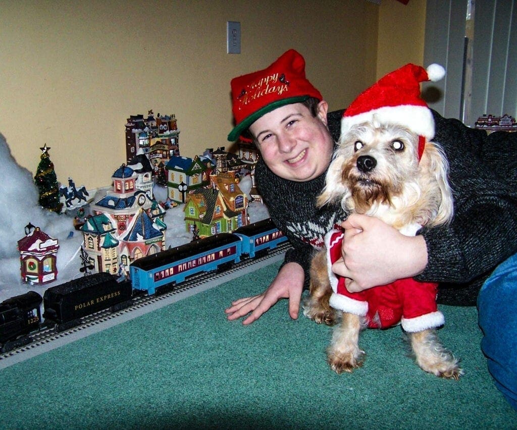 A boy with his dog at Christmas.