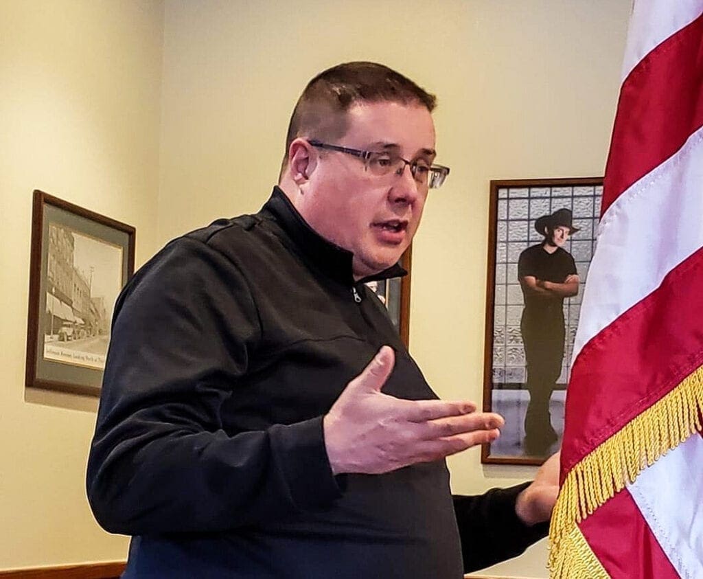 A man near an American Flag.