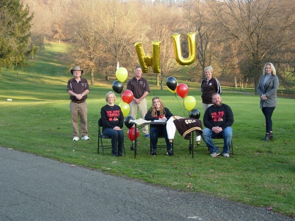 A photo of people at a golf course.