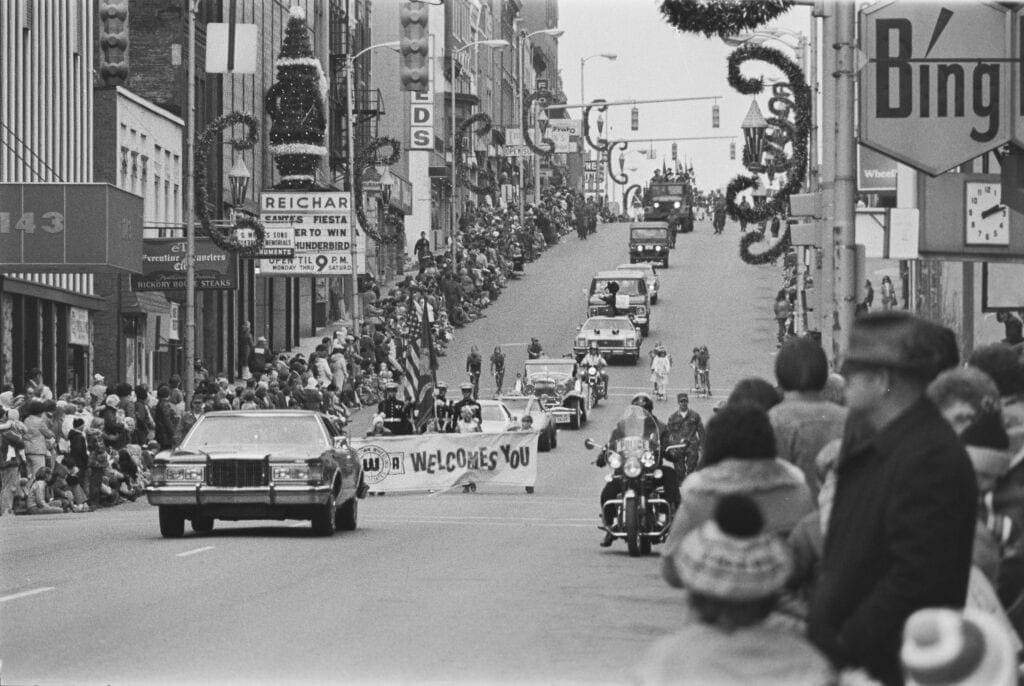 A Christmas parade in a downtown.