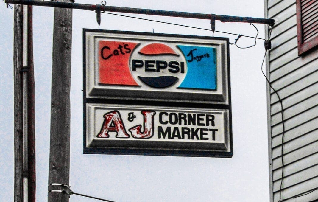 A grocery store sign with Pepsi on it.