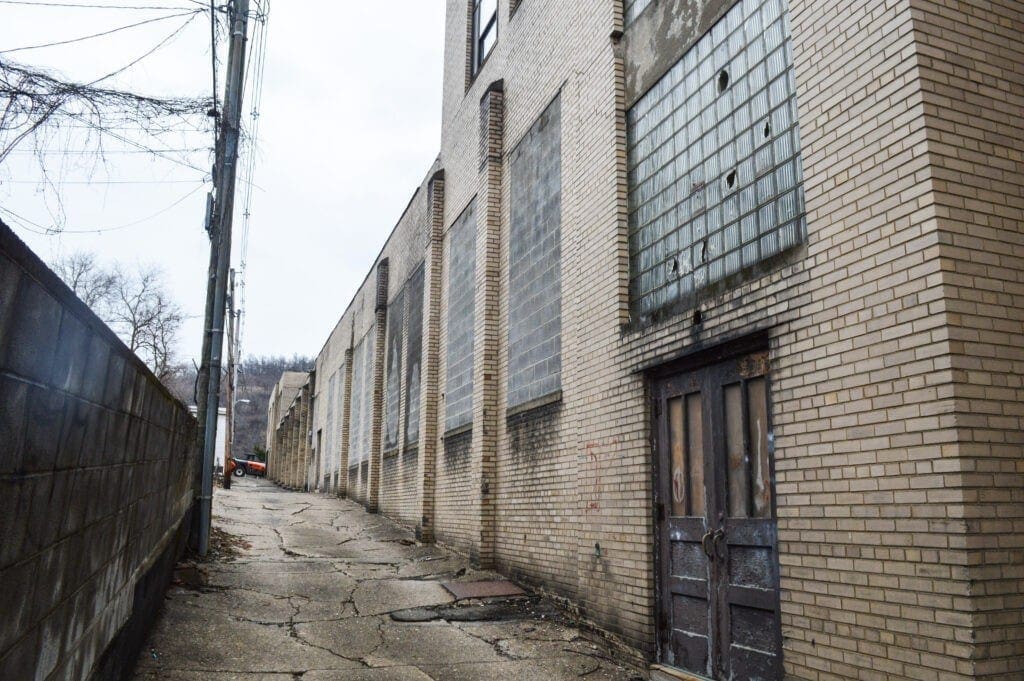 An alley behind an old school.