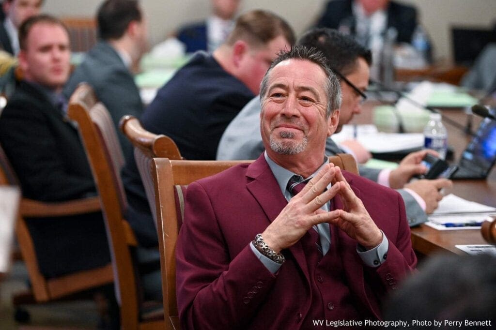 A man sitting and smiling.