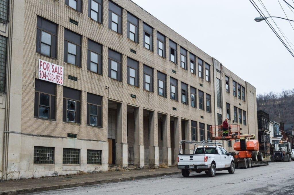 An old school along a city block.