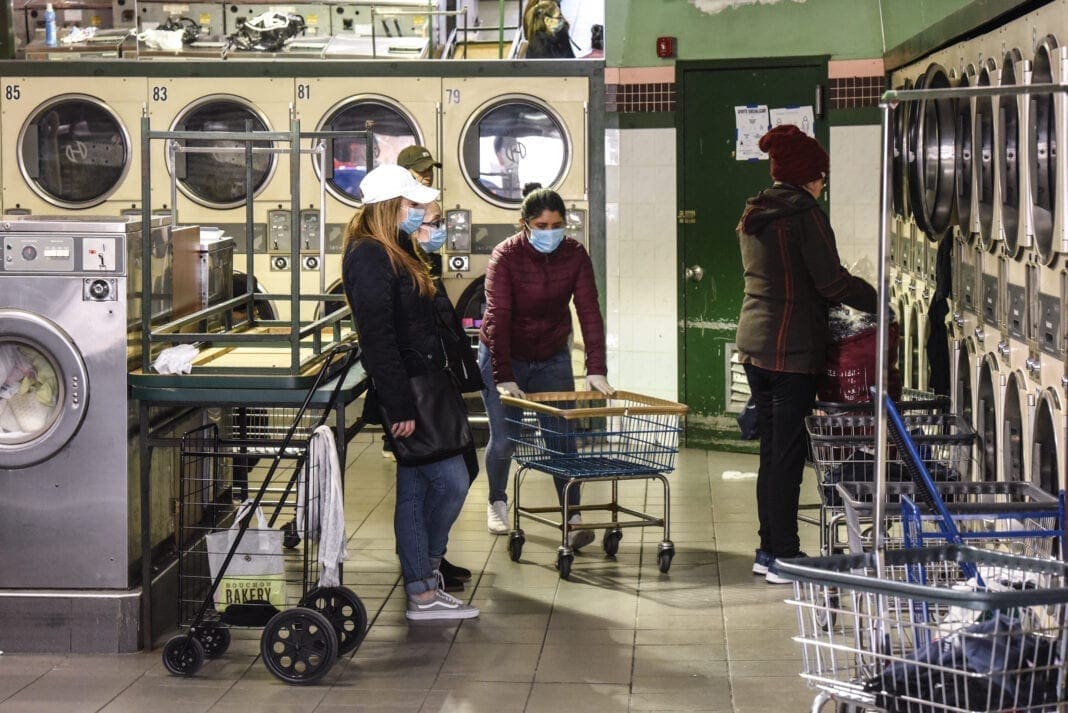 Three women in a laundramat.