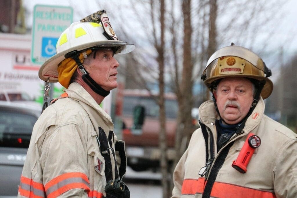 Two firefighters battling a fire.