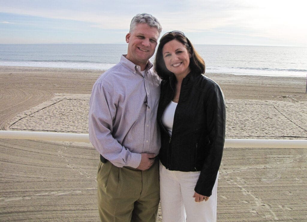 A husband and wife at the beach.