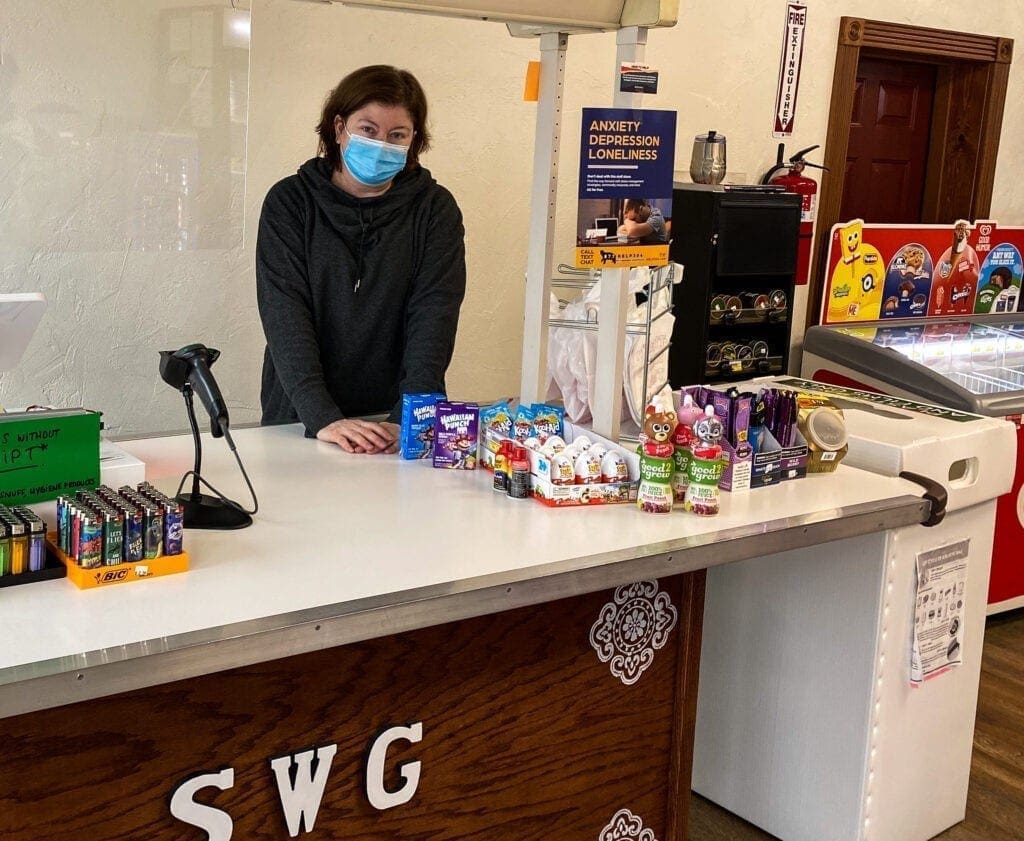 A lady behind a counter.