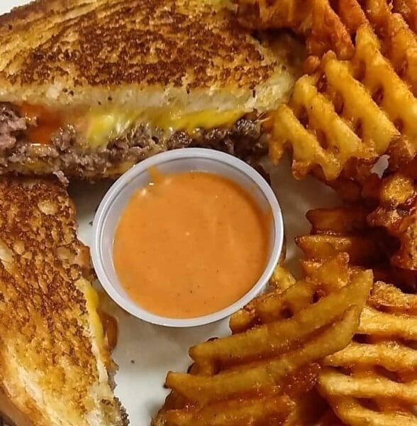 A sandwich with waffle fries.