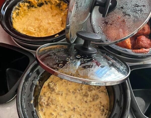 A few crockpots filled with food.