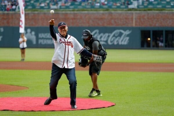 An older fellow throwing a baseball.