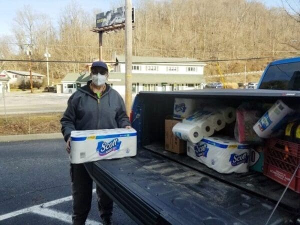 A volunteer helps to load items