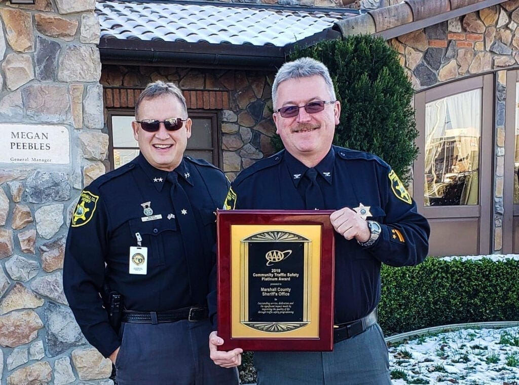 Two men in law enforcement uniforms.