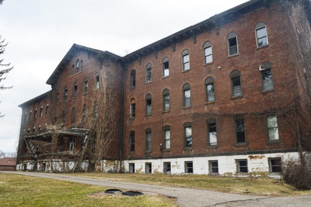 A large brick building that is three stories.