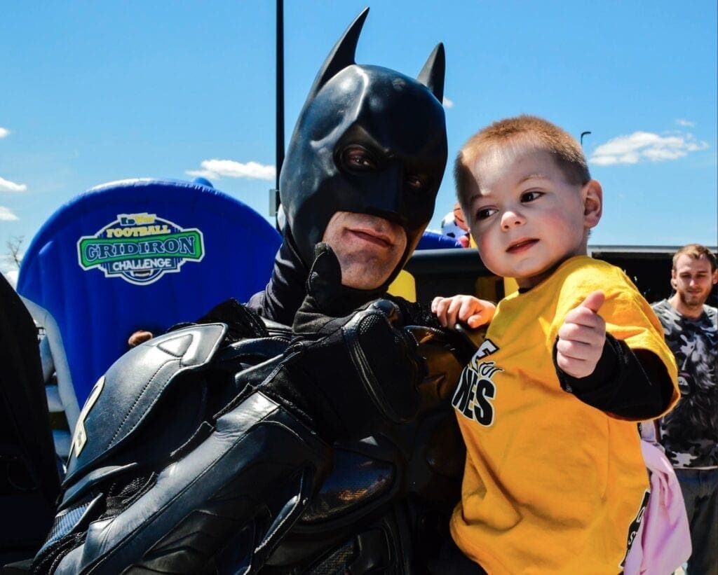 A child held by Batman.