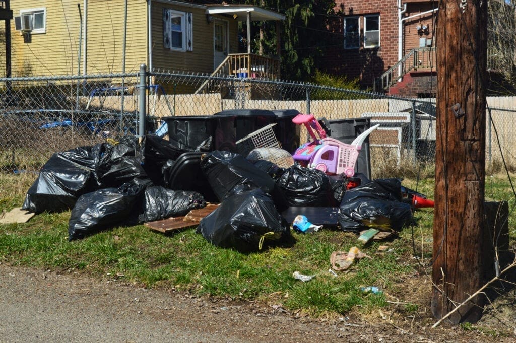 A bunch of garbage along an alley.