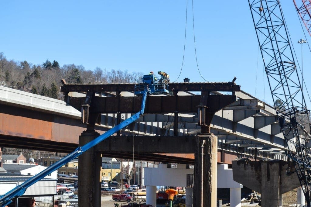 Workers removing a bridge.