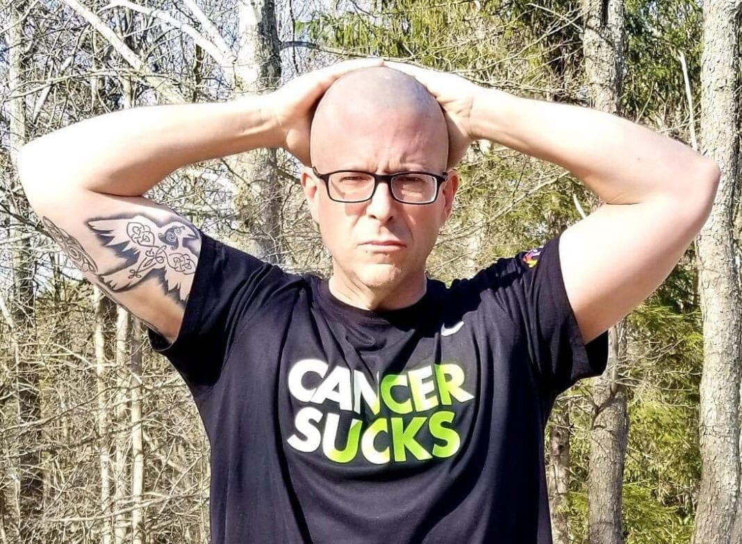 A bald man wearing glasses.