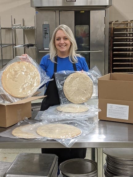 Kocher shows off some of her packaged pizza crusts