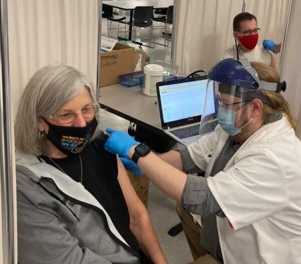 An older lady getting vaccinated.