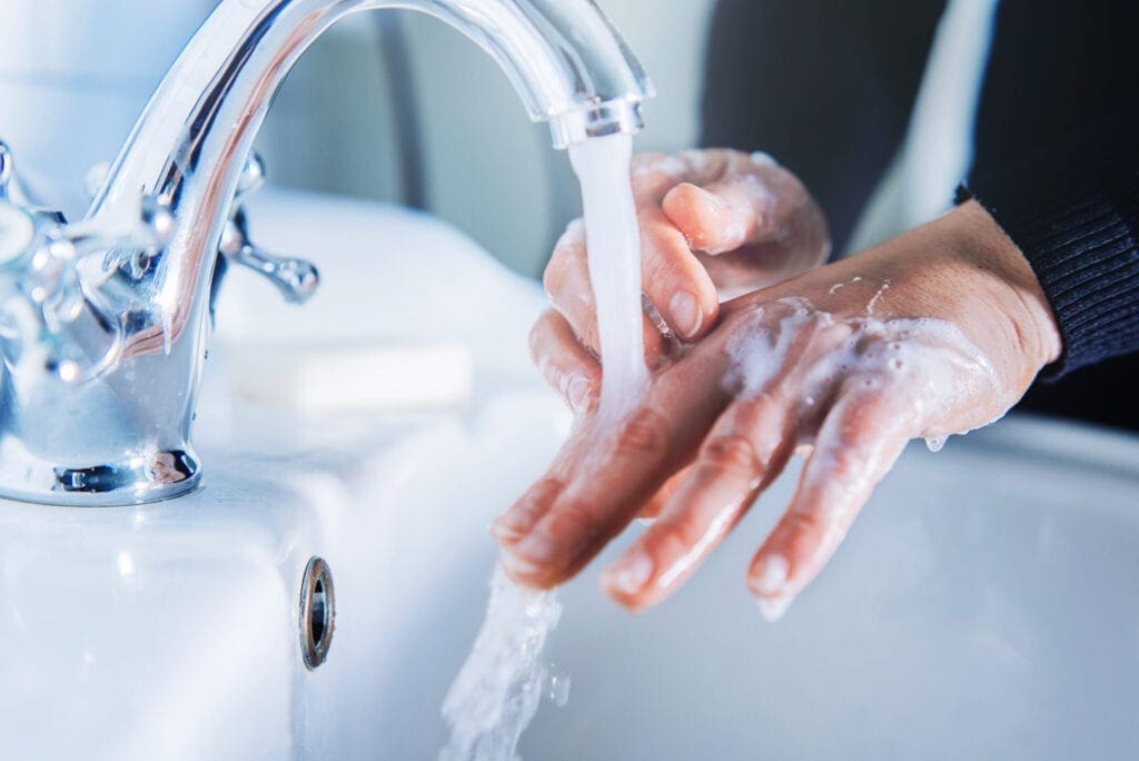 A photo of a person washing their hands.