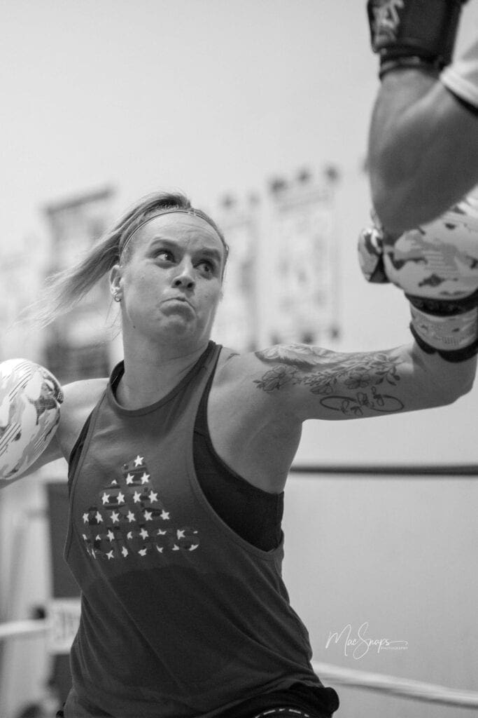 A female getting ready to punch a bag.