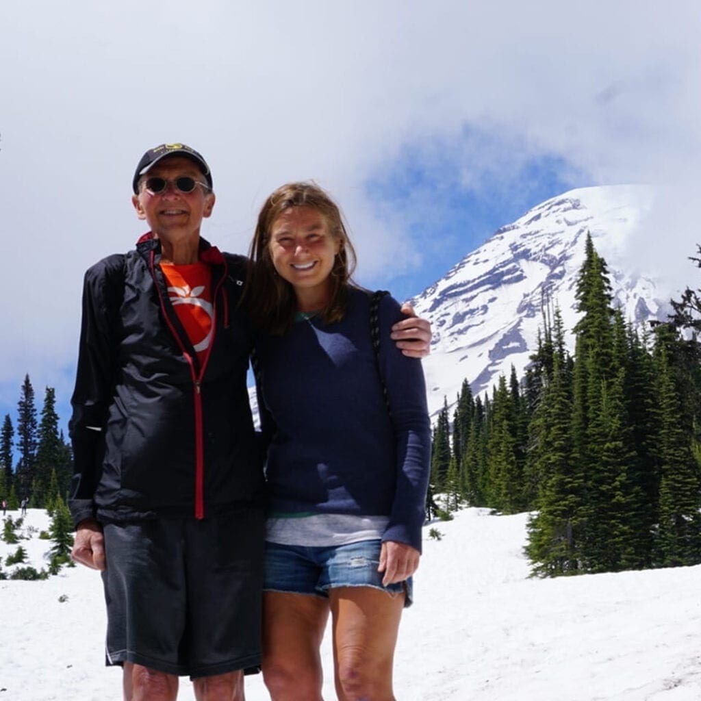 Abby and her dad pose for a photo inside Mt. Rainier National Park