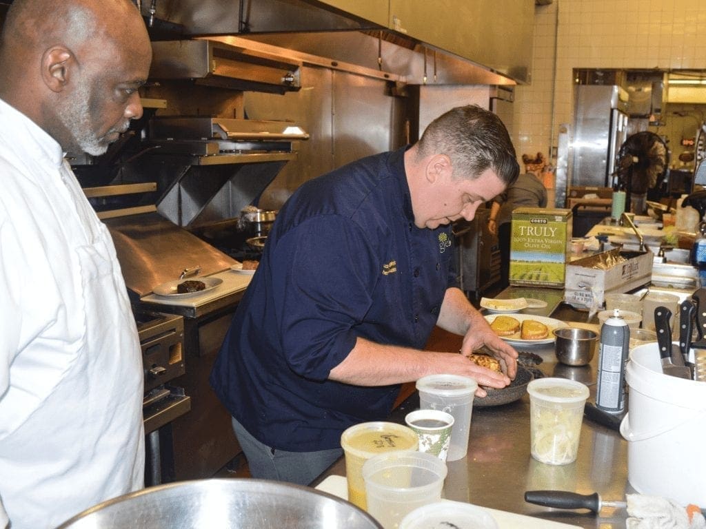 A chef plating a dish.