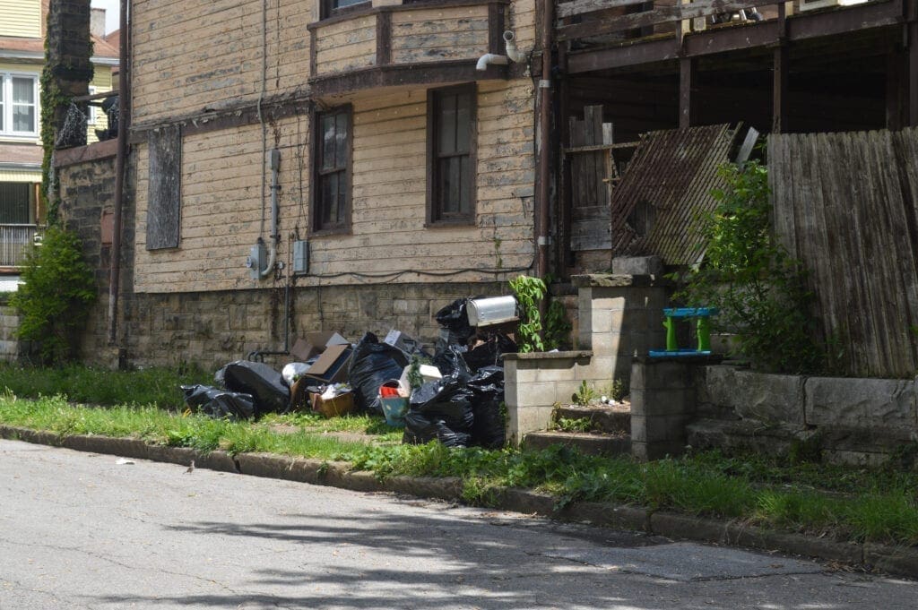 A bunch of garbage outside a house. during enforcement operation  during enforcement operation on Wheeling Island