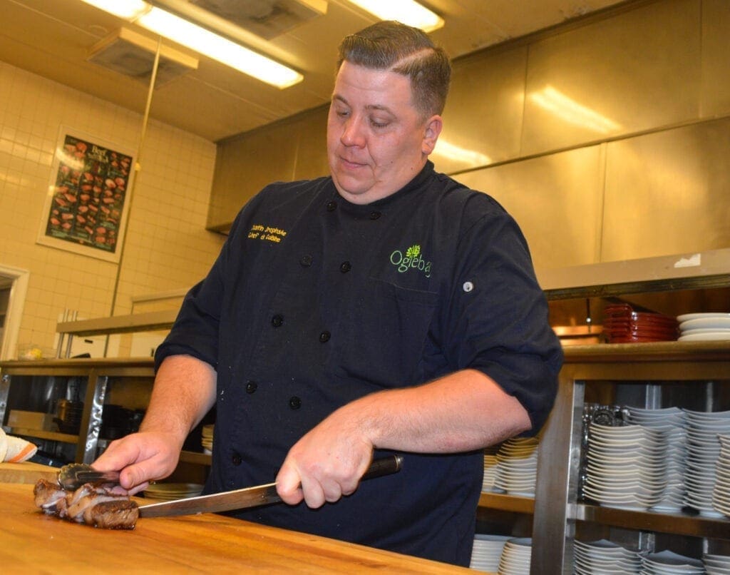 A chef cutting meat.