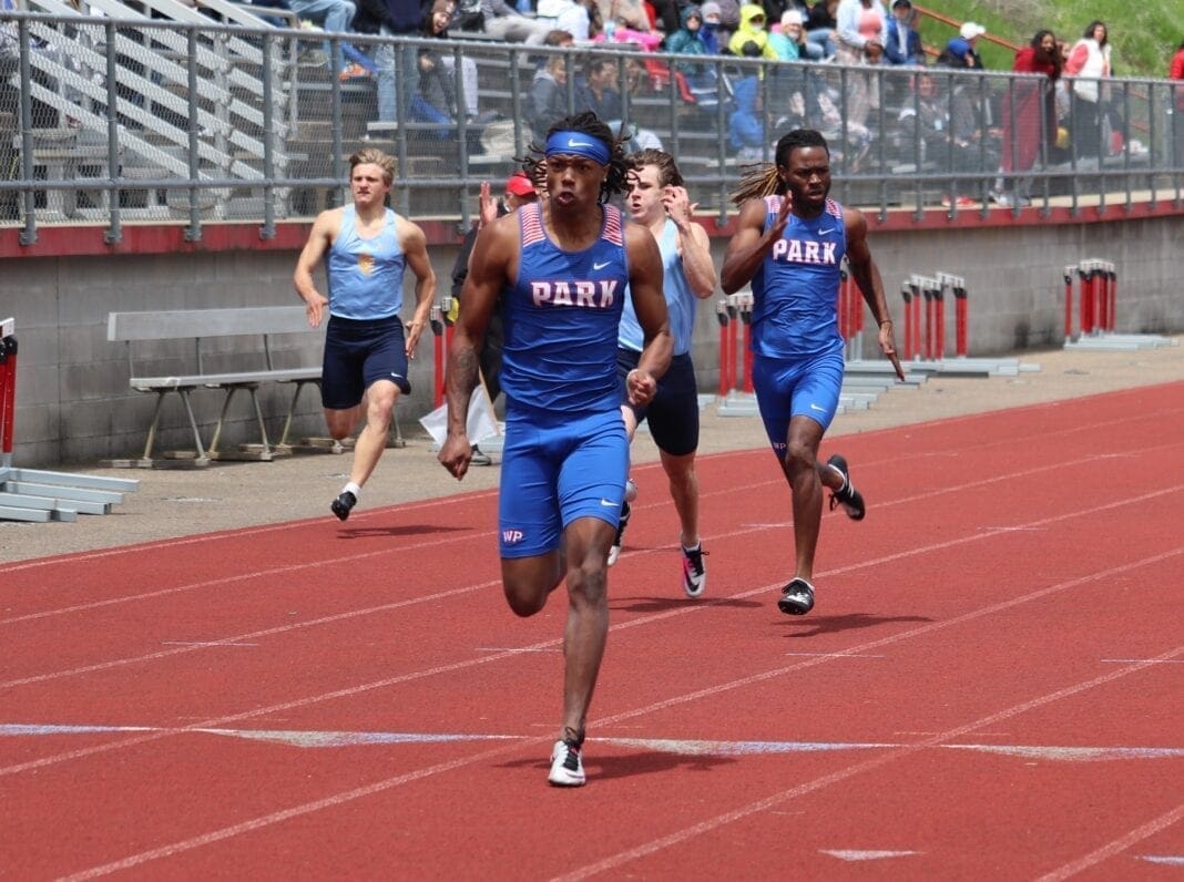 Torrence Walker crosses the finish line first in the 200