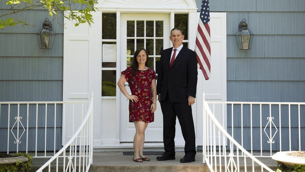 Two people on a porch.