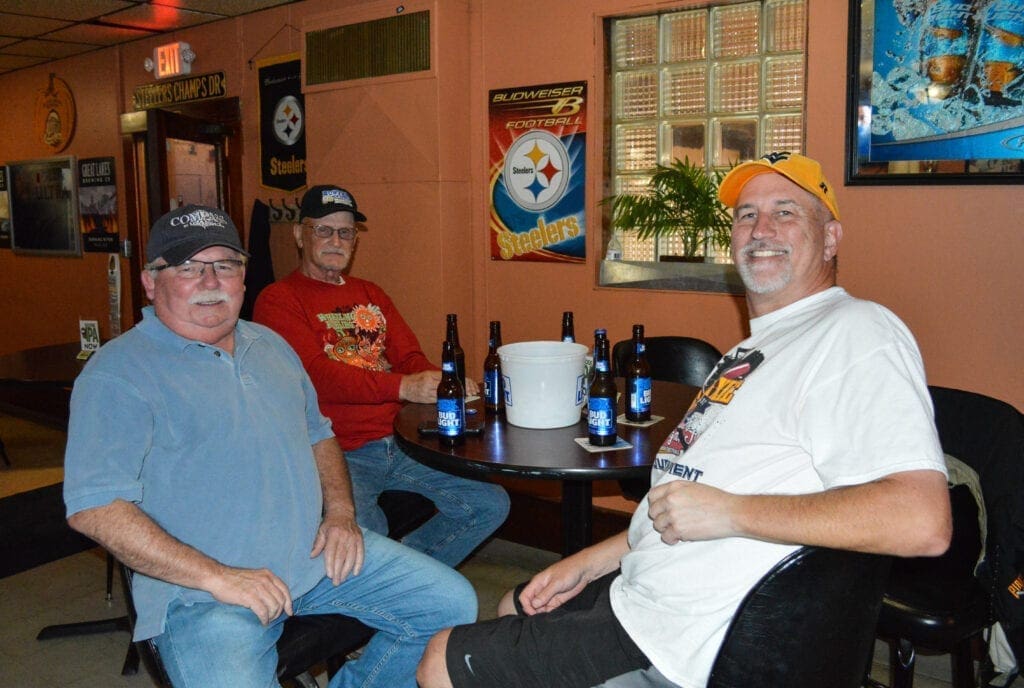 Three men at a table.