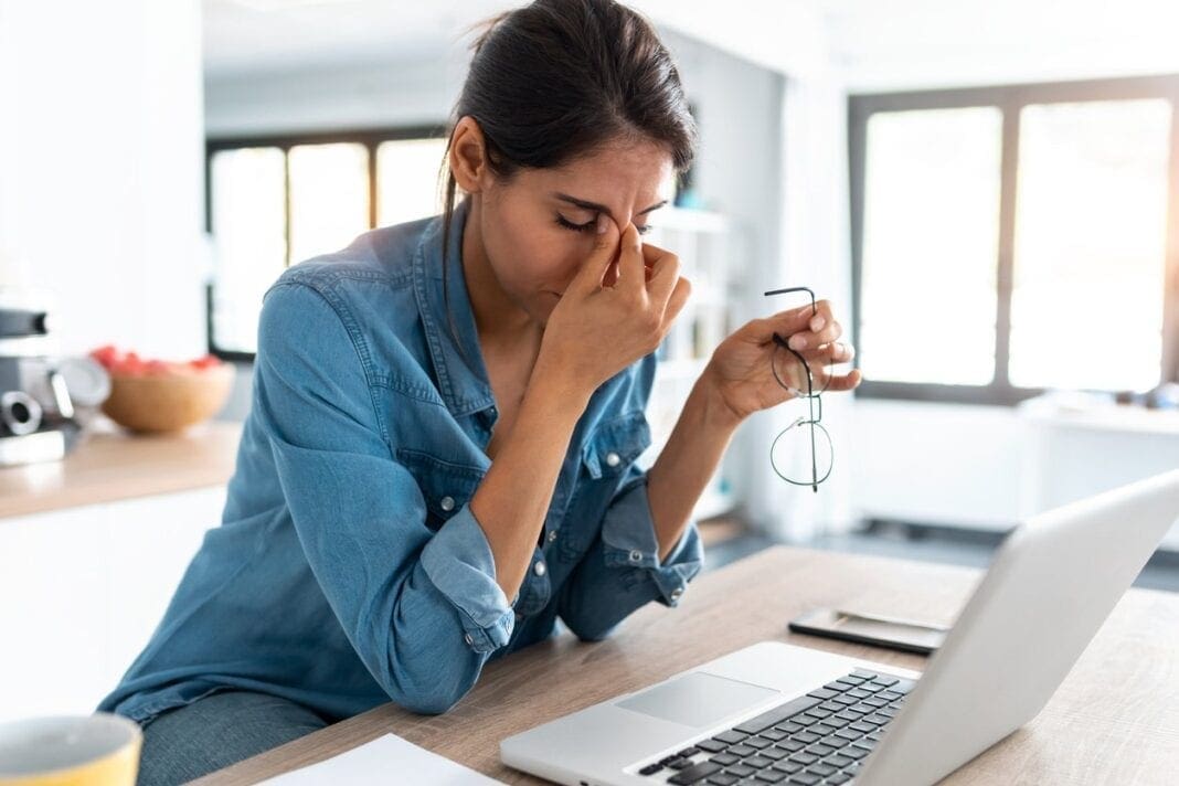 A female in front of a computer.