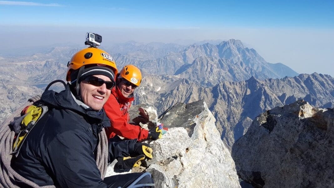 Two men on top of a mountain.