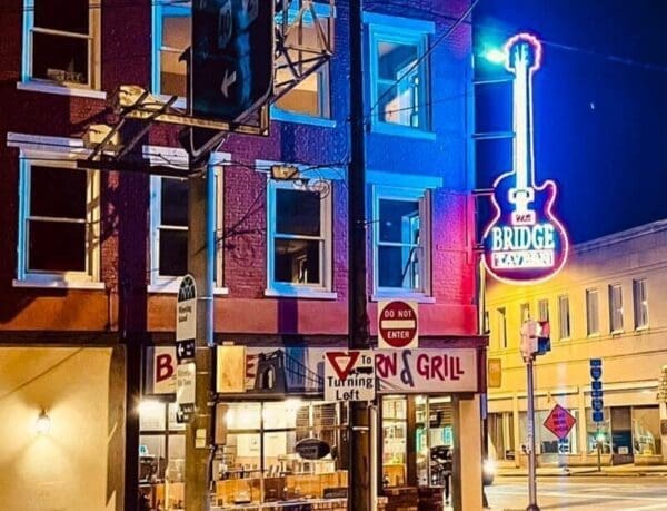 A neon sign on a building at night.