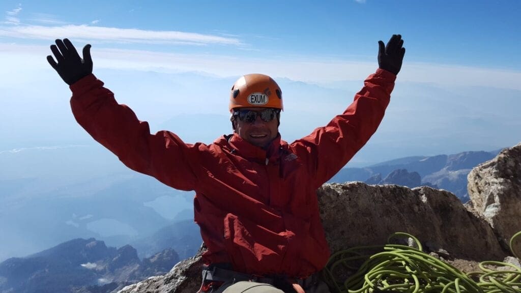 A man at the top of a mountain.