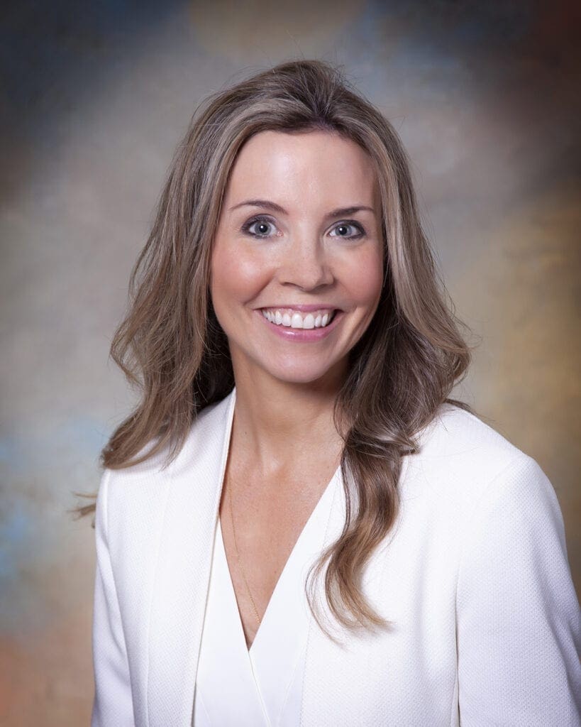 A female in a white blouse.