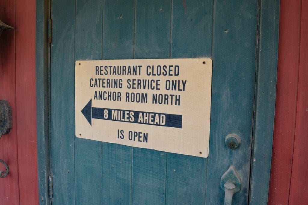 A sign on a green door.