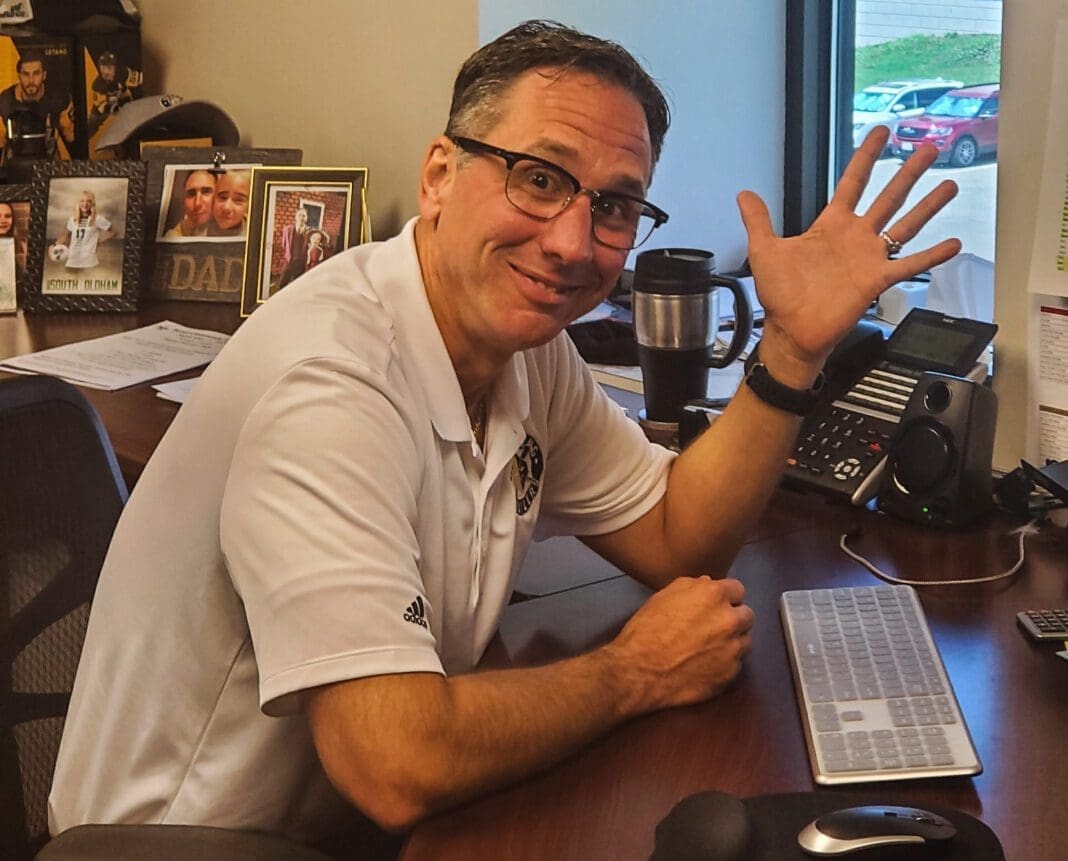 A man waving to the camera.