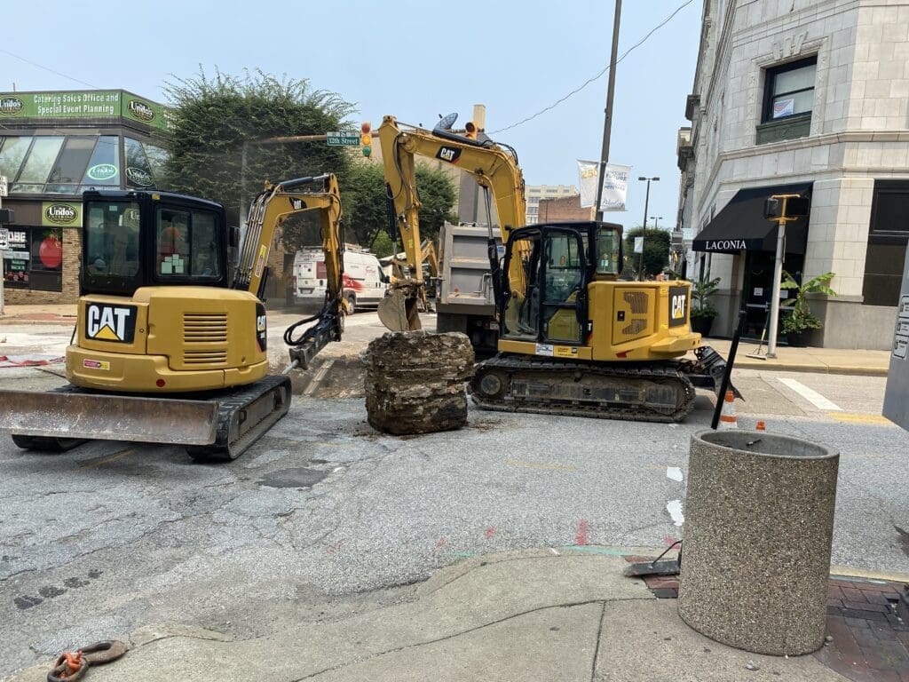 Yellow construction equipment in a road.