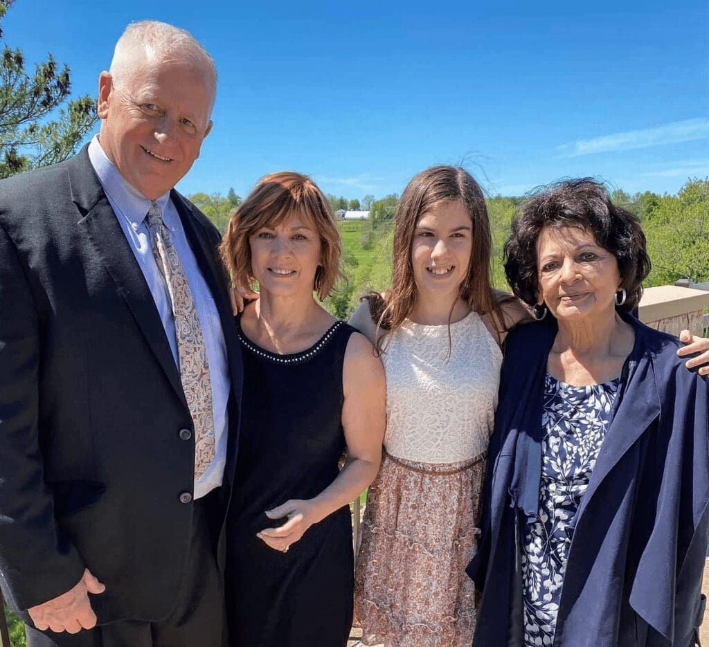 A family photo of three females and a male.