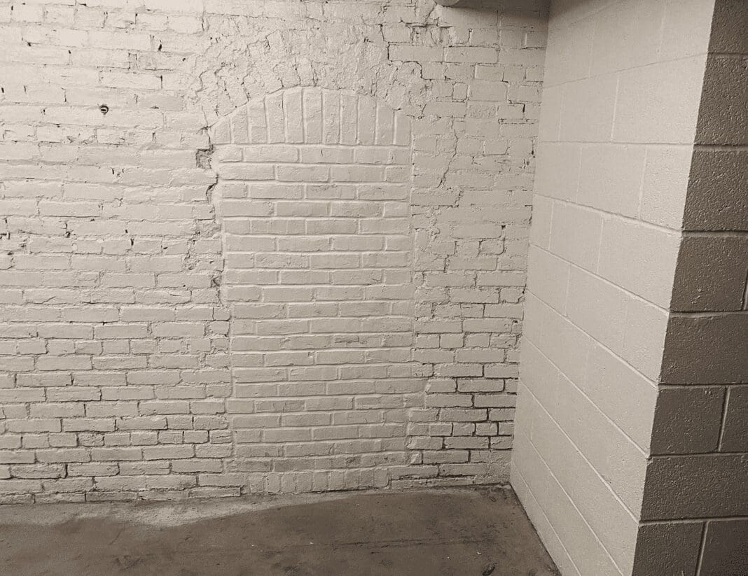 A bricked-in area in a basement of a historic building.