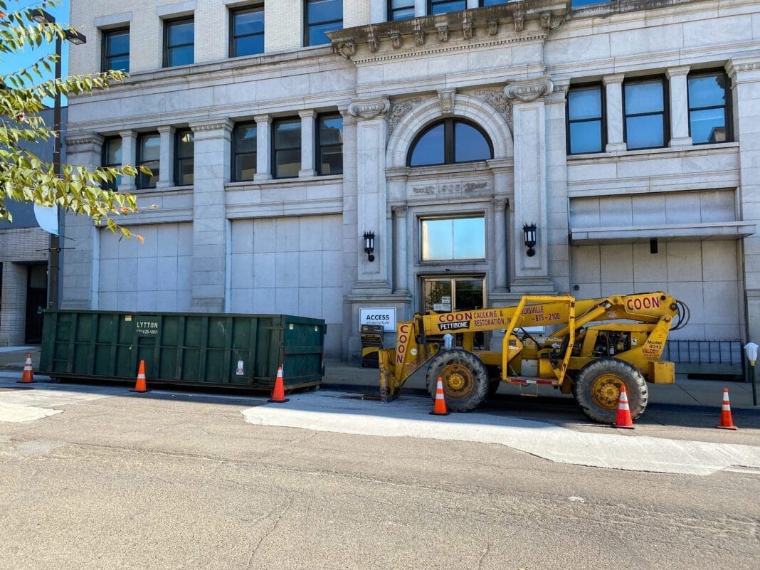 A dumpster in front of a building.