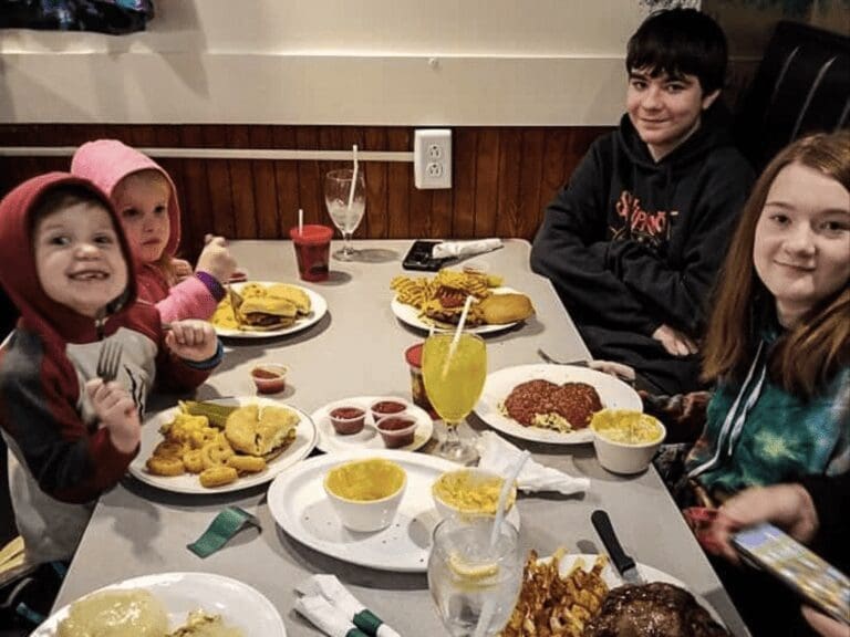 A restaurant table with kids.
