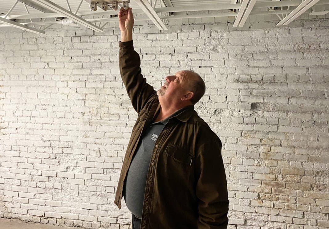 A man checking a ceiling.